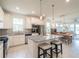 Modern kitchen with white cabinets, granite countertops, stainless steel appliances, and an island with seating at 19212 Iron Topsail Isle, Land O Lakes, FL 34638
