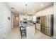 Bright kitchen featuring white cabinets, stainless steel appliances, granite countertops and a center island at 19212 Iron Topsail Isle, Land O Lakes, FL 34638