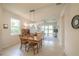 Open floor plan with a dining area connecting to a living space at 19212 Iron Topsail Isle, Land O Lakes, FL 34638