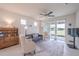 Bright living room featuring a ceiling fan, tile floor, and sliding glass door at 19212 Iron Topsail Isle, Land O Lakes, FL 34638