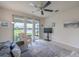 Inviting living room with a ceiling fan, large sliding glass doors to the patio, and neutral decor at 19212 Iron Topsail Isle, Land O Lakes, FL 34638