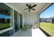 Covered patio featuring comfortable seating, a ceiling fan, and scenic views of the lush green lawn, perfect for relaxation at 19212 Iron Topsail Isle, Land O Lakes, FL 34638