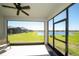 Screened in patio with tranquil lake view, ceiling fan, and ample space for outdoor relaxation and enjoyment at 19212 Iron Topsail Isle, Land O Lakes, FL 34638