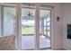 Enjoy the view of the lake through the sliding glass doors with decorative curtains from the lanai at 19212 Iron Topsail Isle, Land O Lakes, FL 34638