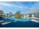 Community pool featuring palm trees and a central island feature at 19212 Iron Topsail Isle, Land O Lakes, FL 34638