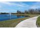 Scenic paved walking path around a picturesque lake with a fountain, perfect for outdoor activities at 19212 Iron Topsail Isle, Land O Lakes, FL 34638