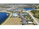 Aerial shot features the community pool, tennis courts, parking, and a serene lake at 19793 Long Lake Ranch Blvd, Lutz, FL 33558