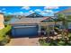 Beautiful home with a well-manicured lawn, palm trees, and stunning lake views in a desirable neighborhood at 19793 Long Lake Ranch Blvd, Lutz, FL 33558