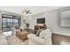 Inviting living room with a view of the lake, featuring neutral tones, ceiling fan and an entertainment center at 19793 Long Lake Ranch Blvd, Lutz, FL 33558