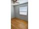 A bedroom is enhanced by hardwood floors, a ceiling fan, and natural light from a window at 2109 52Nd N Ave, St Petersburg, FL 33714