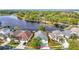 Stunning aerial view of a lakeside home with lush landscaping and a private dock at 2327 Shirecrest Cove Way, Lutz, FL 33558