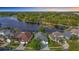 Stunning aerial view of lakefront homes, lush landscaping, and serene water views in a desirable community at 2327 Shirecrest Cove Way, Lutz, FL 33558