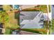 Aerial view showcases a well-maintained roof, manicured lawn, and mature landscaping that provide serene privacy at 2327 Shirecrest Cove Way, Lutz, FL 33558