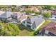 Aerial view of the home's backyard, screened-in pool, and surrounding properties in a well-manicured neighborhood at 2327 Shirecrest Cove Way, Lutz, FL 33558
