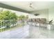 Spacious balcony featuring comfortable seating and a scenic view of the tranquil lake and surrounding nature at 2327 Shirecrest Cove Way, Lutz, FL 33558