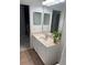 Bathroom with a granite vanity top, with views into the bathroom and laundry area at 2327 Shirecrest Cove Way, Lutz, FL 33558