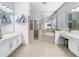 Bright bathroom featuring dual vanities, a walk-in shower, and a soaking tub at 2327 Shirecrest Cove Way, Lutz, FL 33558
