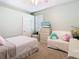 Well-lit bedroom showcasing the bed, love seat, ceiling fan, and dresser at 2327 Shirecrest Cove Way, Lutz, FL 33558