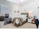 This is a cozy bedroom featuring a soft bed, bedside table, and decorative artwork at 2327 Shirecrest Cove Way, Lutz, FL 33558