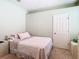 Cozy bedroom featuring carpet, soft pink accents, and a comfortable bed at 2327 Shirecrest Cove Way, Lutz, FL 33558