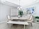 Dining area featuring an oval table, stylish chairs, a decorative plant, and elegant light fixture at 2327 Shirecrest Cove Way, Lutz, FL 33558