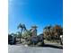 The gated entrance to Cambridge Cove welcomes you with palm trees and a clear blue sky at 2327 Shirecrest Cove Way, Lutz, FL 33558