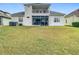 Back exterior with upper balcony, lower screened porch and spacious yard at 2327 Shirecrest Cove Way, Lutz, FL 33558