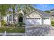 Charming home featuring a well-manicured lawn, a spacious three-car garage, and beautiful landscaping at 2327 Shirecrest Cove Way, Lutz, FL 33558