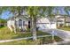 Beautiful home with lush landscaping, a three-car garage, and well-maintained lawn creating exceptional curb appeal at 2327 Shirecrest Cove Way, Lutz, FL 33558