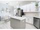 Spacious kitchen with stainless steel refrigerator and island with white countertops at 2327 Shirecrest Cove Way, Lutz, FL 33558