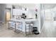 Bright, spacious kitchen with bar stool seating at the island, white countertops and stainless appliances at 2327 Shirecrest Cove Way, Lutz, FL 33558