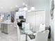 Bright kitchen nook featuring a glass table, white chairs, and white cabinetry, perfect for casual dining at 2327 Shirecrest Cove Way, Lutz, FL 33558