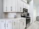 Modern kitchen design with sleek white cabinetry, stainless steel appliances, and updated countertops at 2327 Shirecrest Cove Way, Lutz, FL 33558