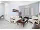 Bright living room showcasing modern sofas, decorative art, and shuttered windows, creating a stylish and welcoming space at 2327 Shirecrest Cove Way, Lutz, FL 33558
