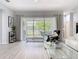 Bright living room with sliding glass doors leading to outdoor area and views of the lake at 2327 Shirecrest Cove Way, Lutz, FL 33558