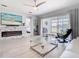 Stylish living room features a modern fireplace, large screen TV, and sliding glass doors to the outdoor living space at 2327 Shirecrest Cove Way, Lutz, FL 33558