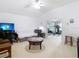 Large room featuring a sofa, coffee table, desk, and views to exercise area at 2327 Shirecrest Cove Way, Lutz, FL 33558