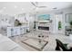 Open concept living room and kitchen with a modern fireplace and a large glass coffee table at 2327 Shirecrest Cove Way, Lutz, FL 33558
