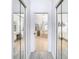 Hallway view to the main bathroom highlighting a soaking tub, glass-enclosed shower, and double vanity at 2327 Shirecrest Cove Way, Lutz, FL 33558