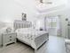 Tranquil main bedroom featuring tray ceilings, a large window and stylish furnishings at 2327 Shirecrest Cove Way, Lutz, FL 33558