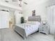 Bright main bedroom featuring tray ceilings, hardwood floors and natural light at 2327 Shirecrest Cove Way, Lutz, FL 33558