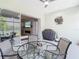 Screened in patio showing a view of the indoor fireplace, lake view, and an outdoor grill at 2327 Shirecrest Cove Way, Lutz, FL 33558