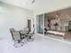 Screened in patio showcasing a view of the indoor living room, kitchen, and outdoor seating at 2327 Shirecrest Cove Way, Lutz, FL 33558