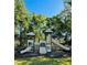 Community playground with slides and climbing structure, surrounded by lush greenery and a bright blue sky at 2327 Shirecrest Cove Way, Lutz, FL 33558