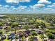 Areal showing properties backing up to a shared green space and a distant lake under blue skies at 2329 Towering Oaks Cir, Seffner, FL 33584