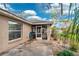 Home exterior featuring a screened in lanai and meticulously maintained yard at 2329 Towering Oaks Cir, Seffner, FL 33584