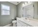 Bathroom with white fixtures, including a toilet, sink, and shower with a safety bar at 2329 Towering Oaks Cir, Seffner, FL 33584