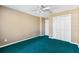 Neutral bedroom featuring blue carpet, a ceiling fan, and closet with white doors at 2329 Towering Oaks Cir, Seffner, FL 33584