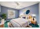 Cozy bedroom features a bed, window with blinds, and an accent wall, perfect for relaxation at 2329 Towering Oaks Cir, Seffner, FL 33584