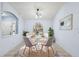 Cozy dining room with a modern chandelier, round table, and large window offering ample natural light at 2329 Towering Oaks Cir, Seffner, FL 33584